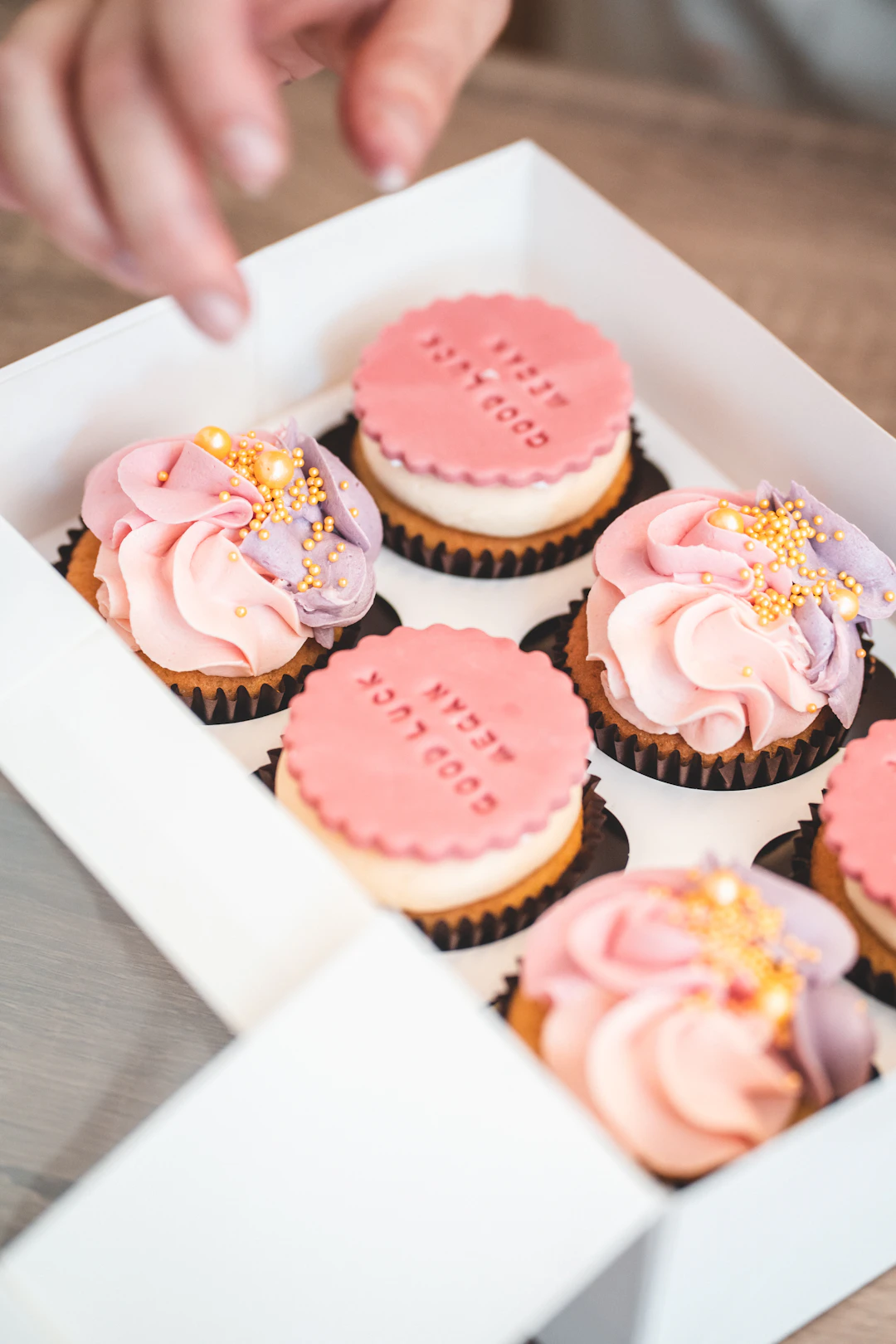 Box of frosted thank you cupcakes ready for gifting to a coworker, teacher, or small team in Los Angeles