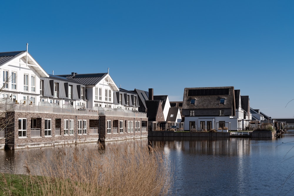 a row of houses next to a body of water