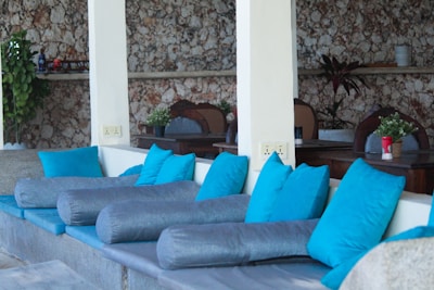 Cozy seating area featuring muted blue cushions and natural wood textures.