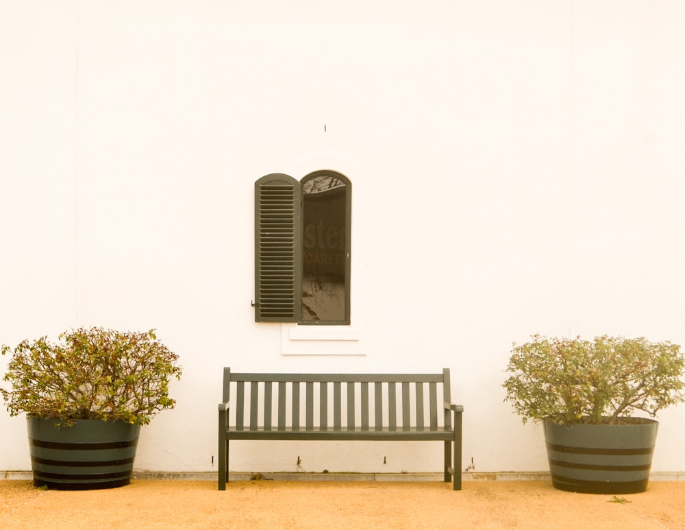 a bench sitting in front of a white building