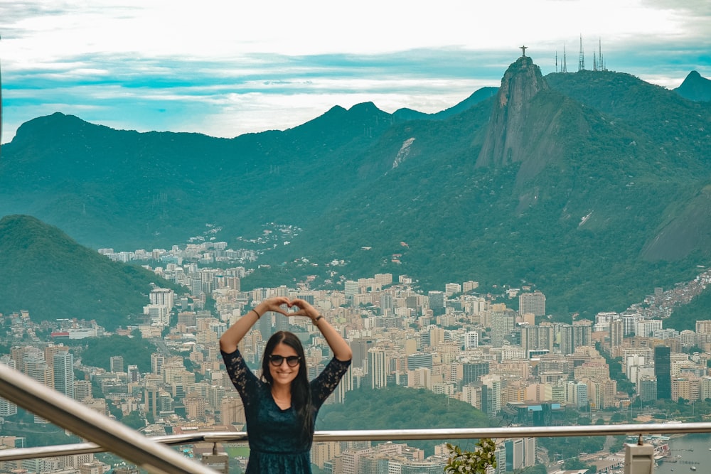 a woman standing on top of a metal railing