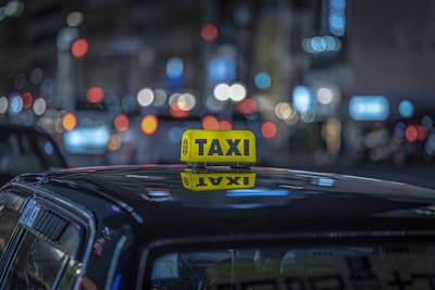 a taxi cab with a yellow taxi sign on top of it