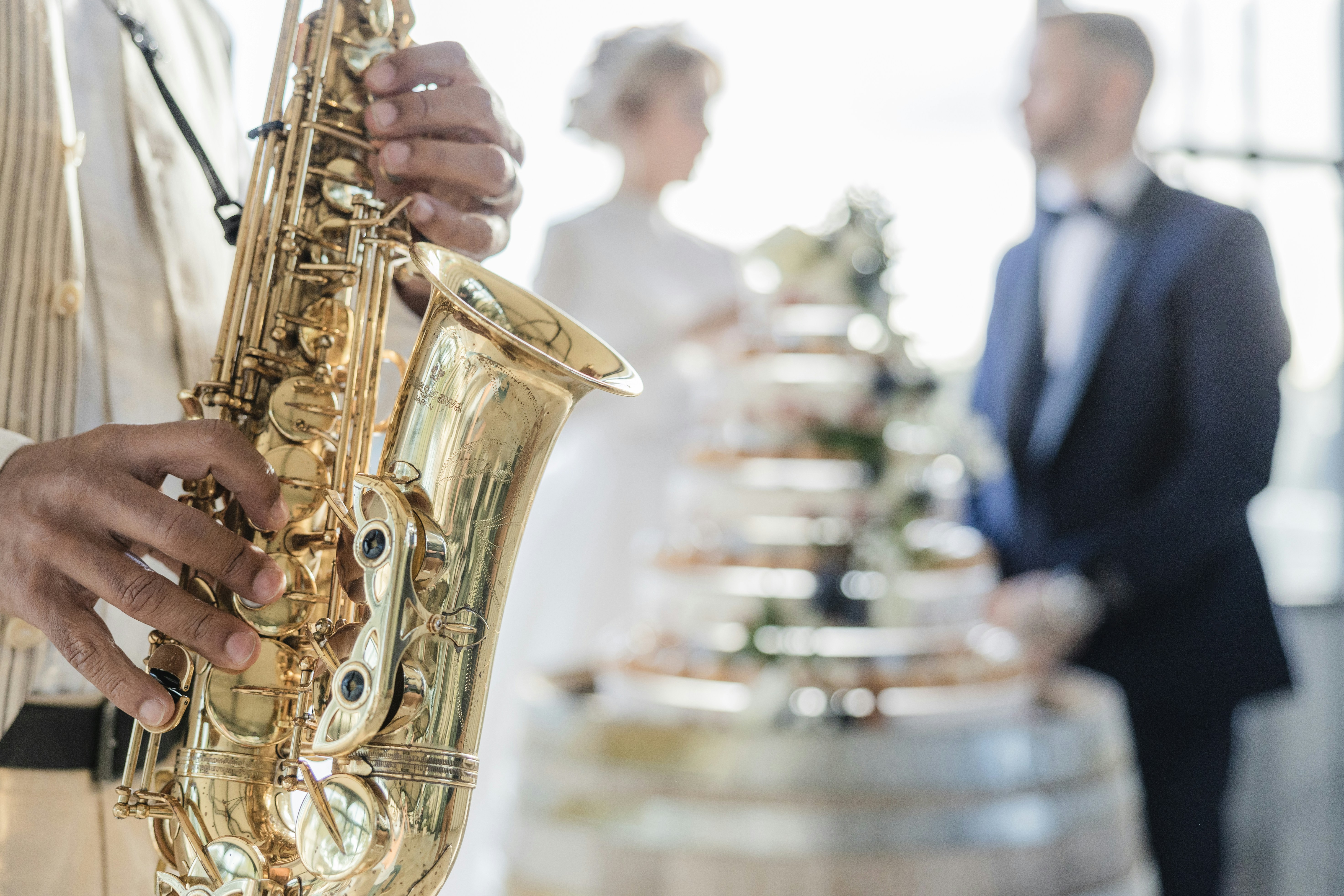a man in a tuxedo playing a saxophone