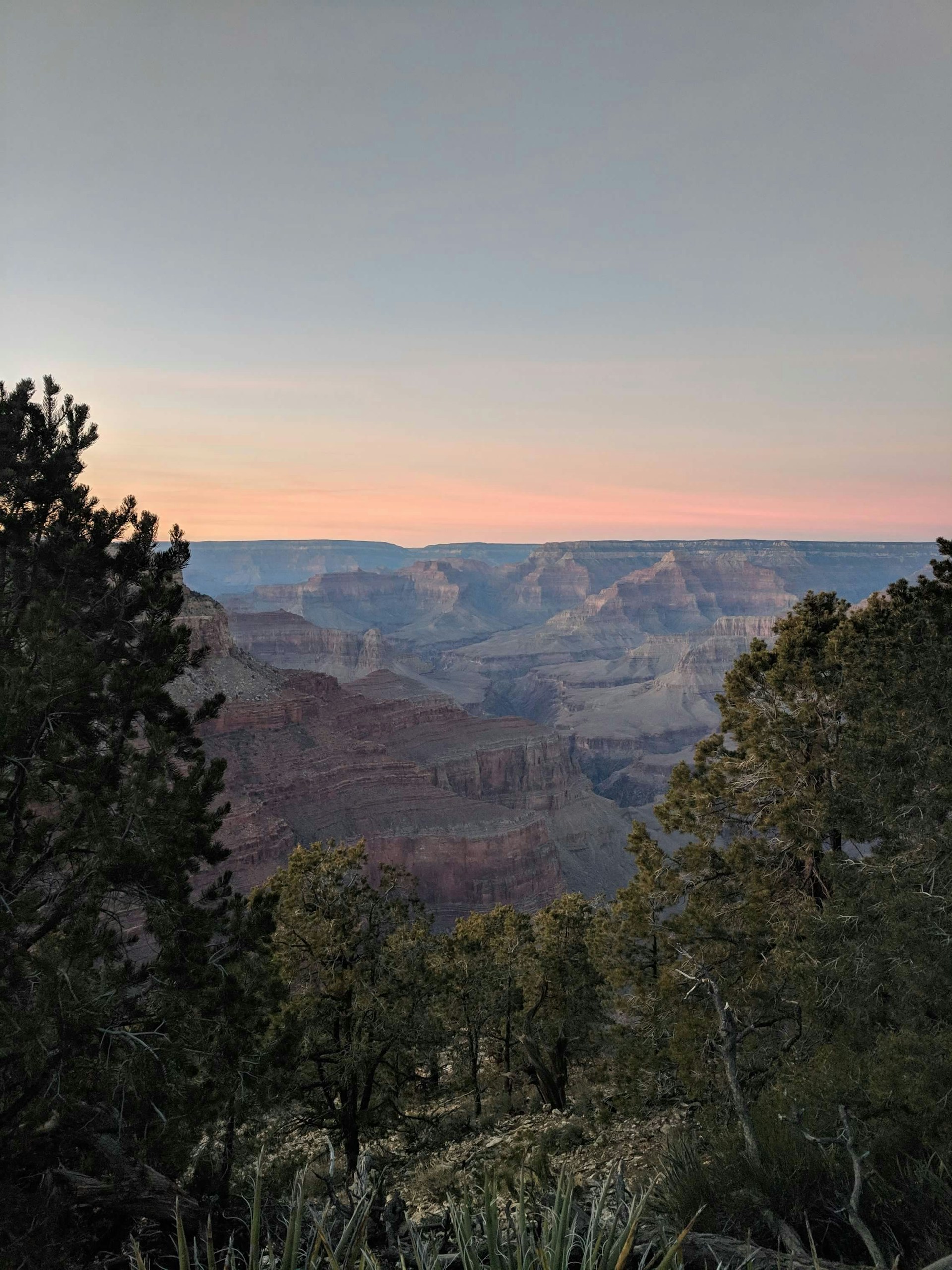 A breathtaking view of the Copper Canyon at sunset, showcasing rugged cliffs and deep valleys.
