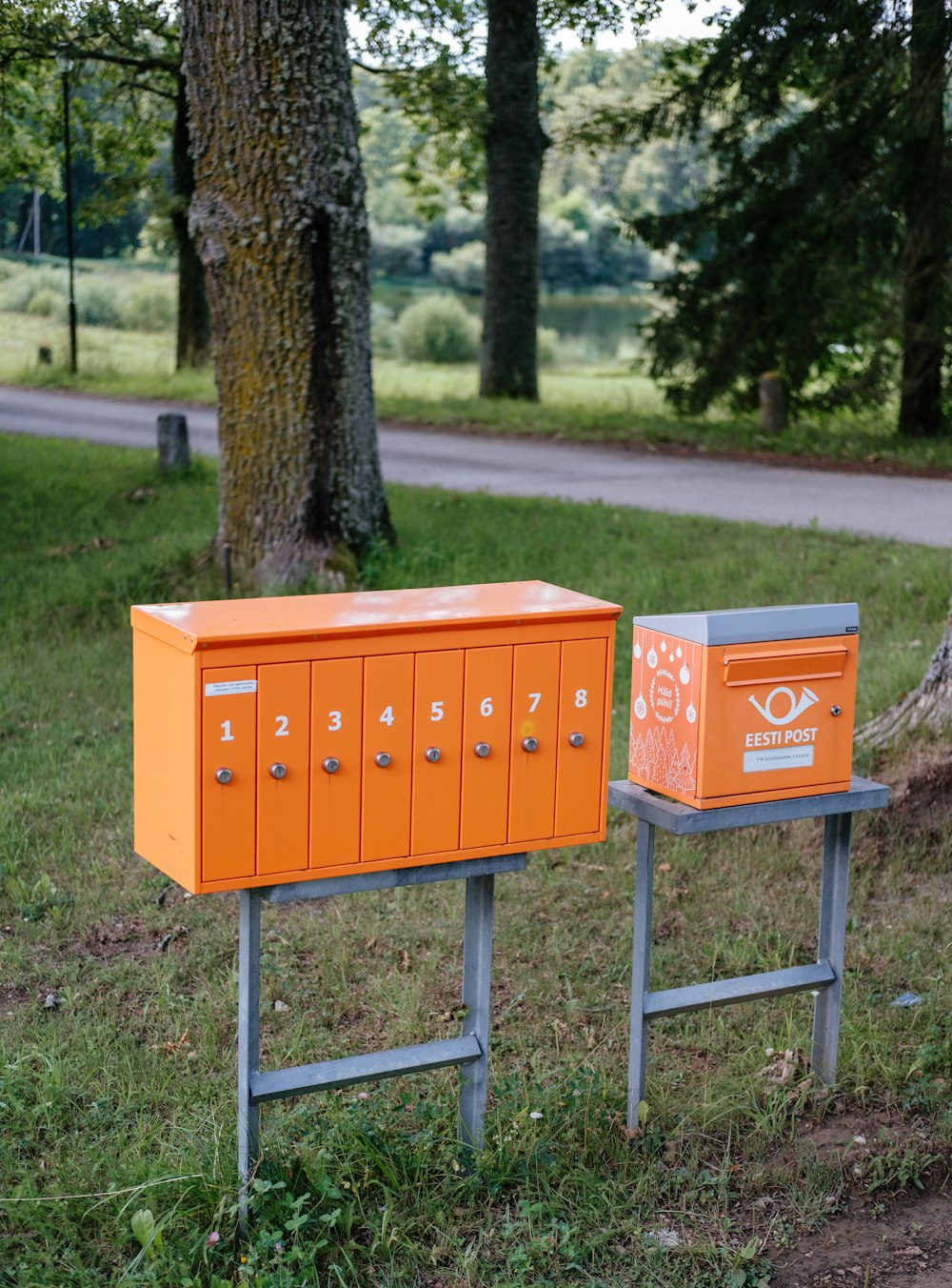 a couple of orange boxes sitting on top of a metal stand