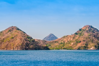 a body of water with mountains in the background