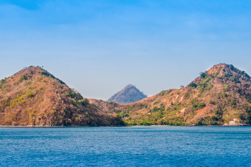 a body of water with mountains in the background