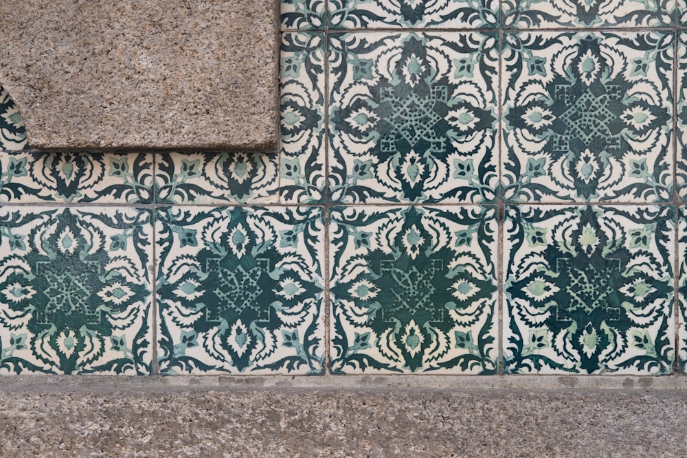 a close up of a wall with a tile design on it