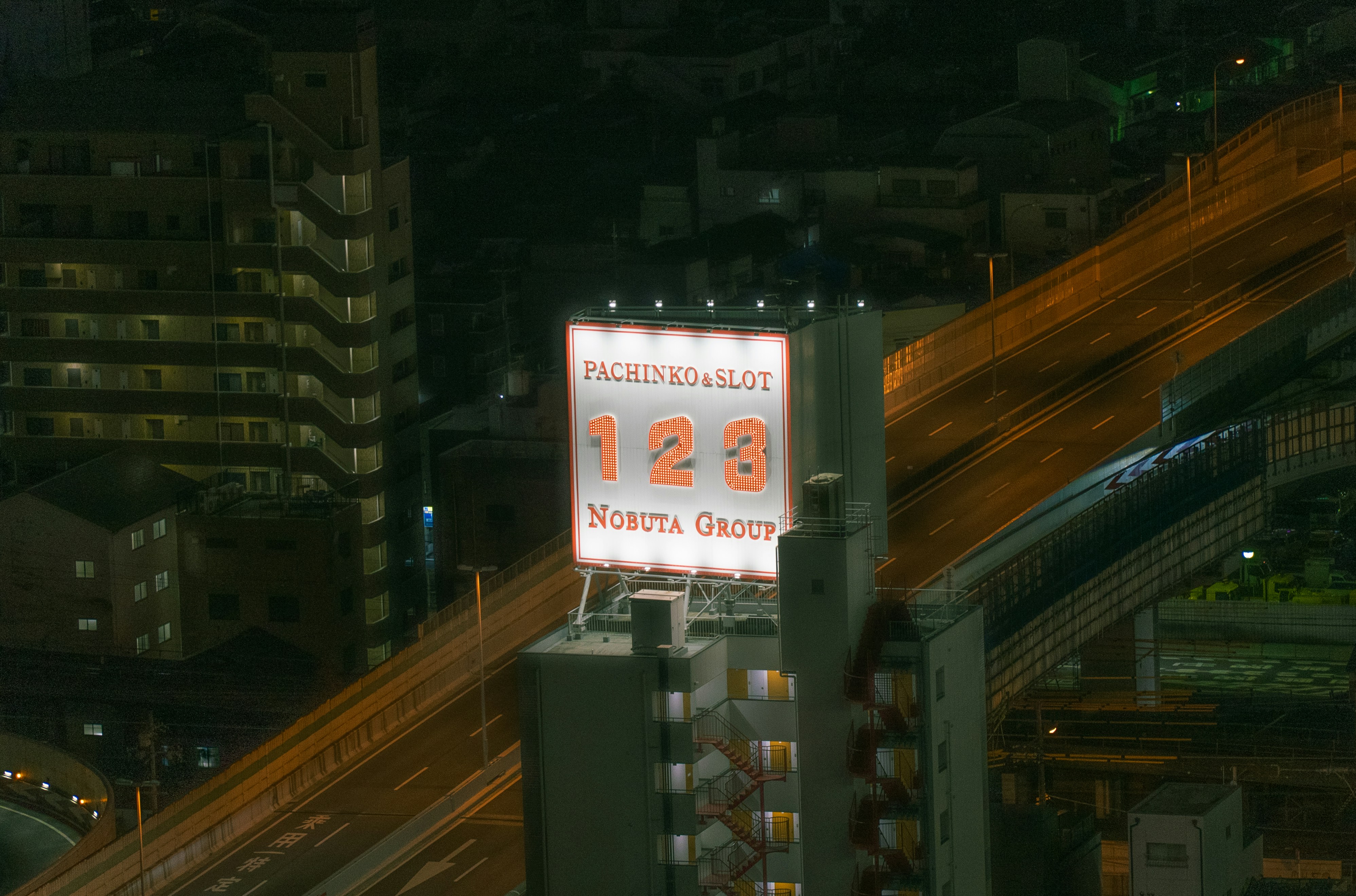 a street sign on top of a tall building