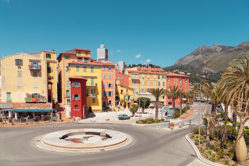 a city street with a fountain in the middle of it