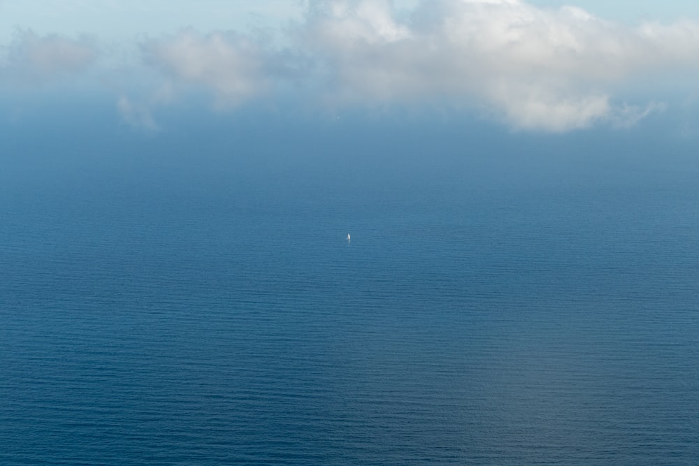 a large body of water under a cloudy sky