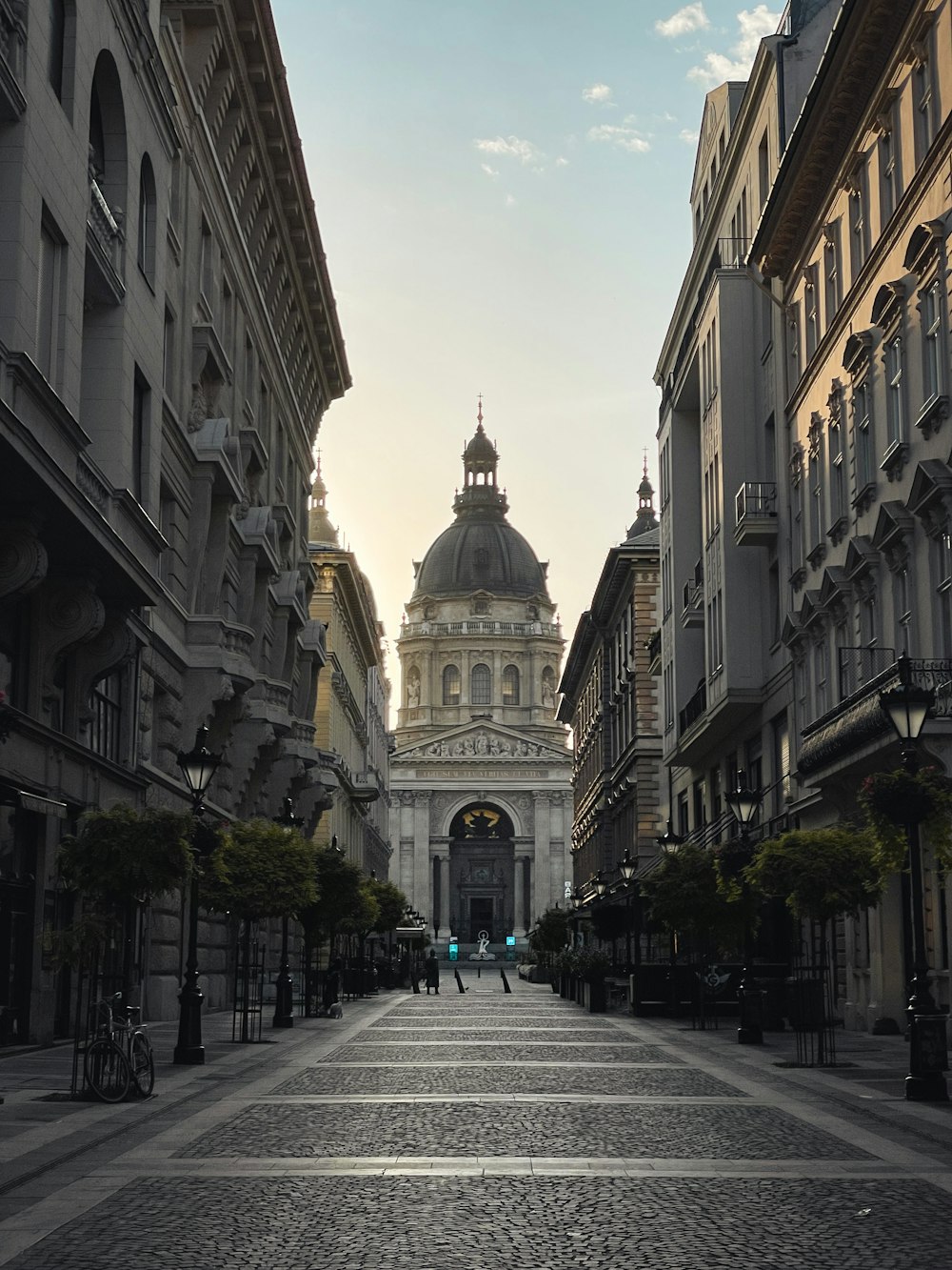 a city street lined with tall buildings with a dome on top