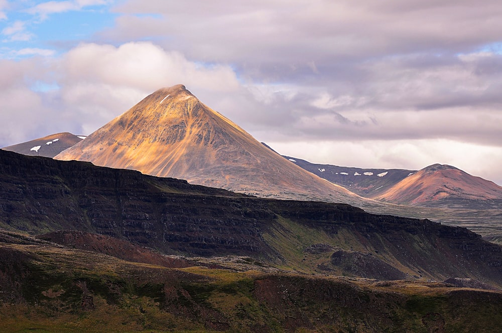 a large mountain with snow on top of it