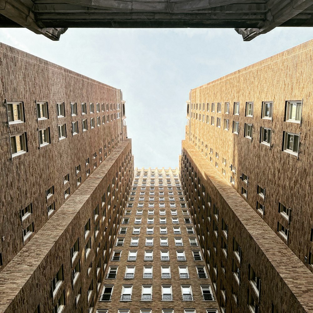 looking up at a tall brick building with windows