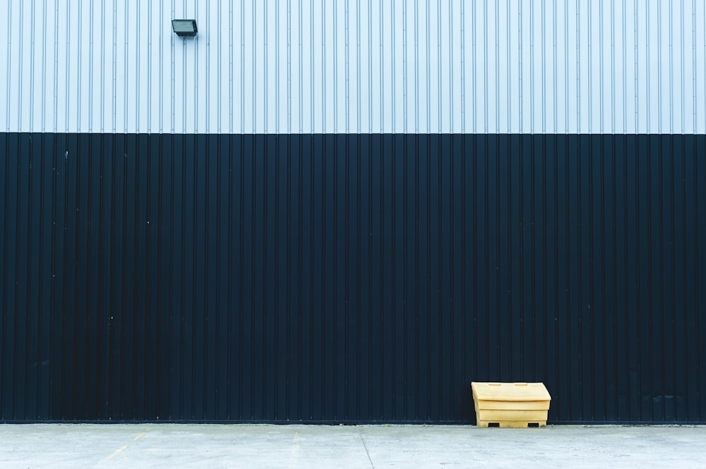 a wooden bench sitting in front of a building