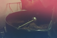 A traditional coffee roasting setup with beans in a pan.