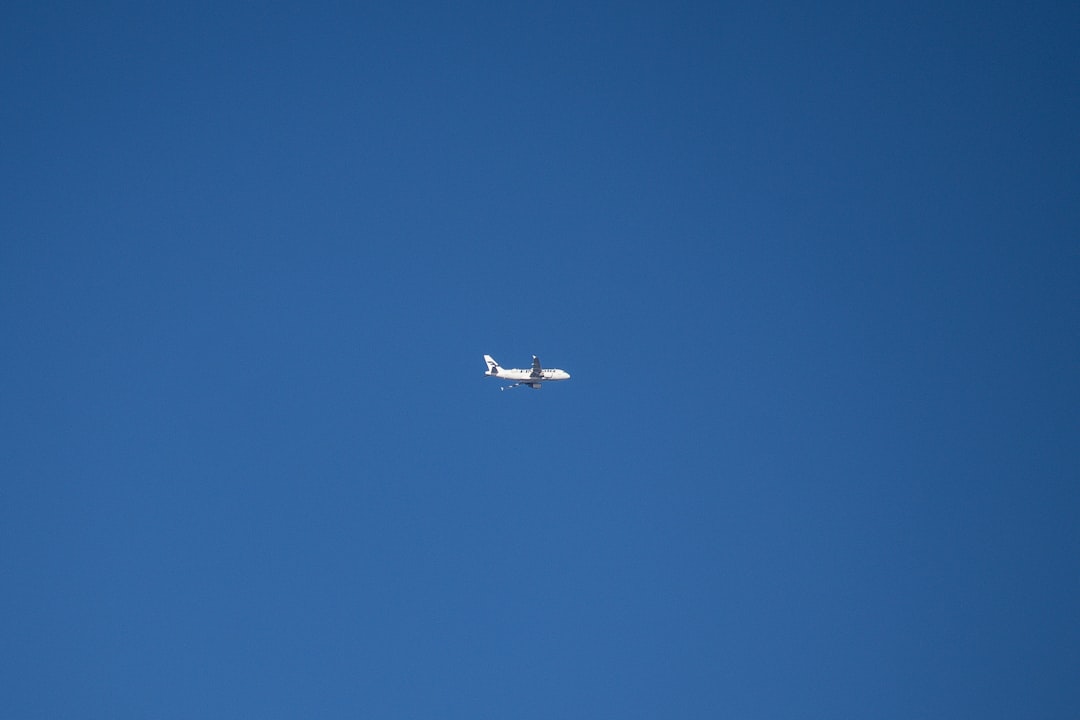 an airplane is flying high in the sky,