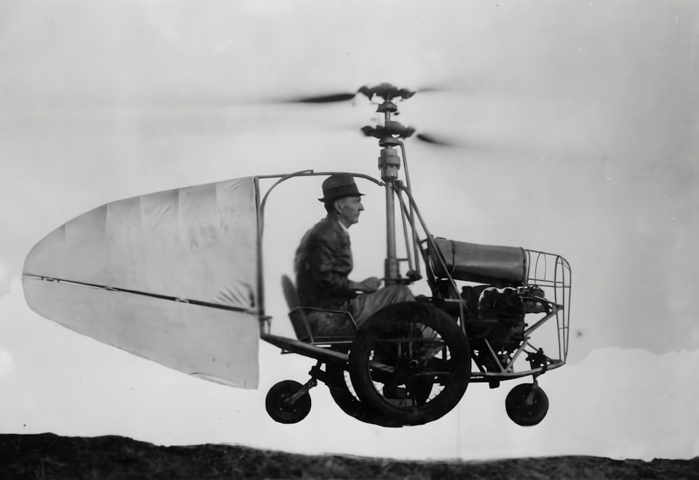 a man flying a small airplane with a propeller