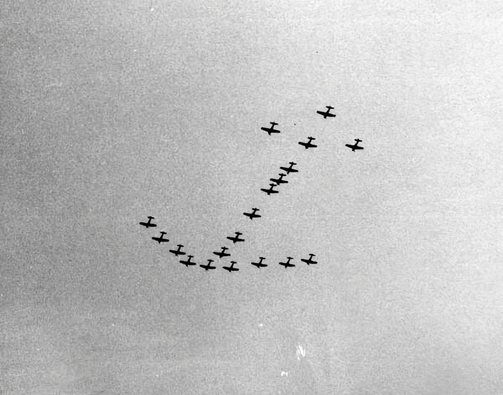 a group of planes flying in formation in the sky