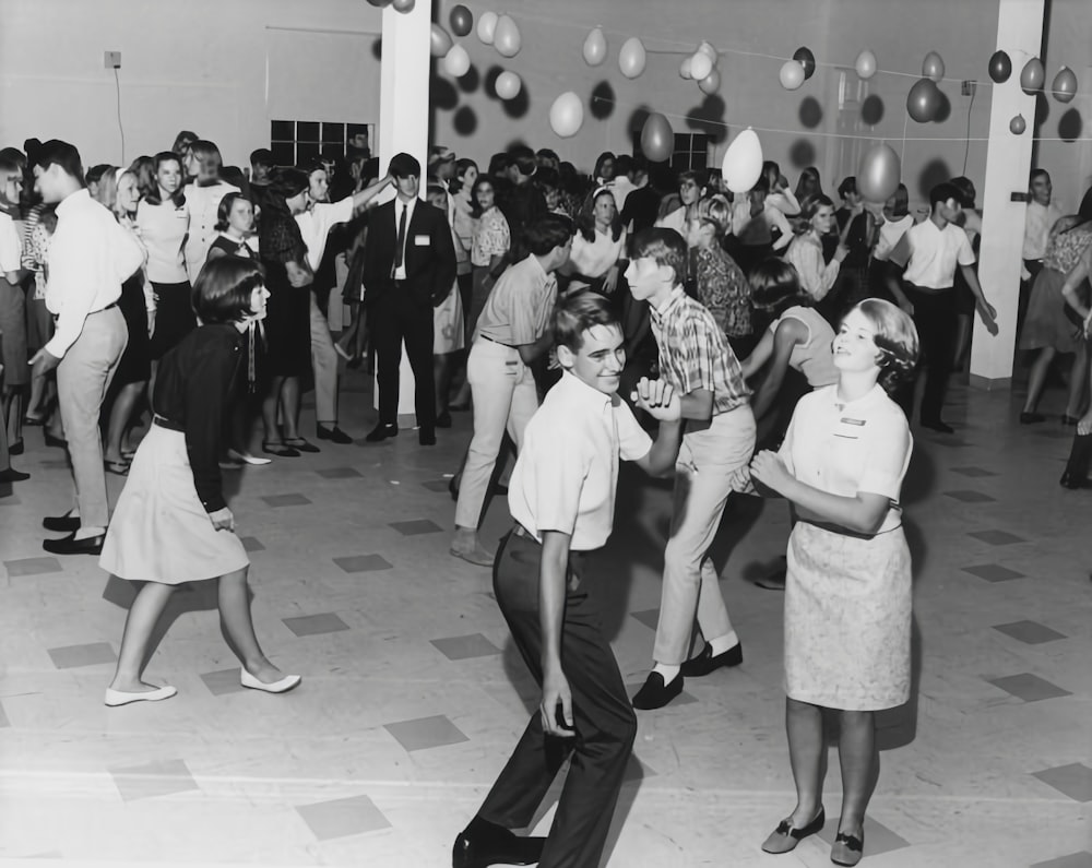 a black and white photo of a group of people dancing