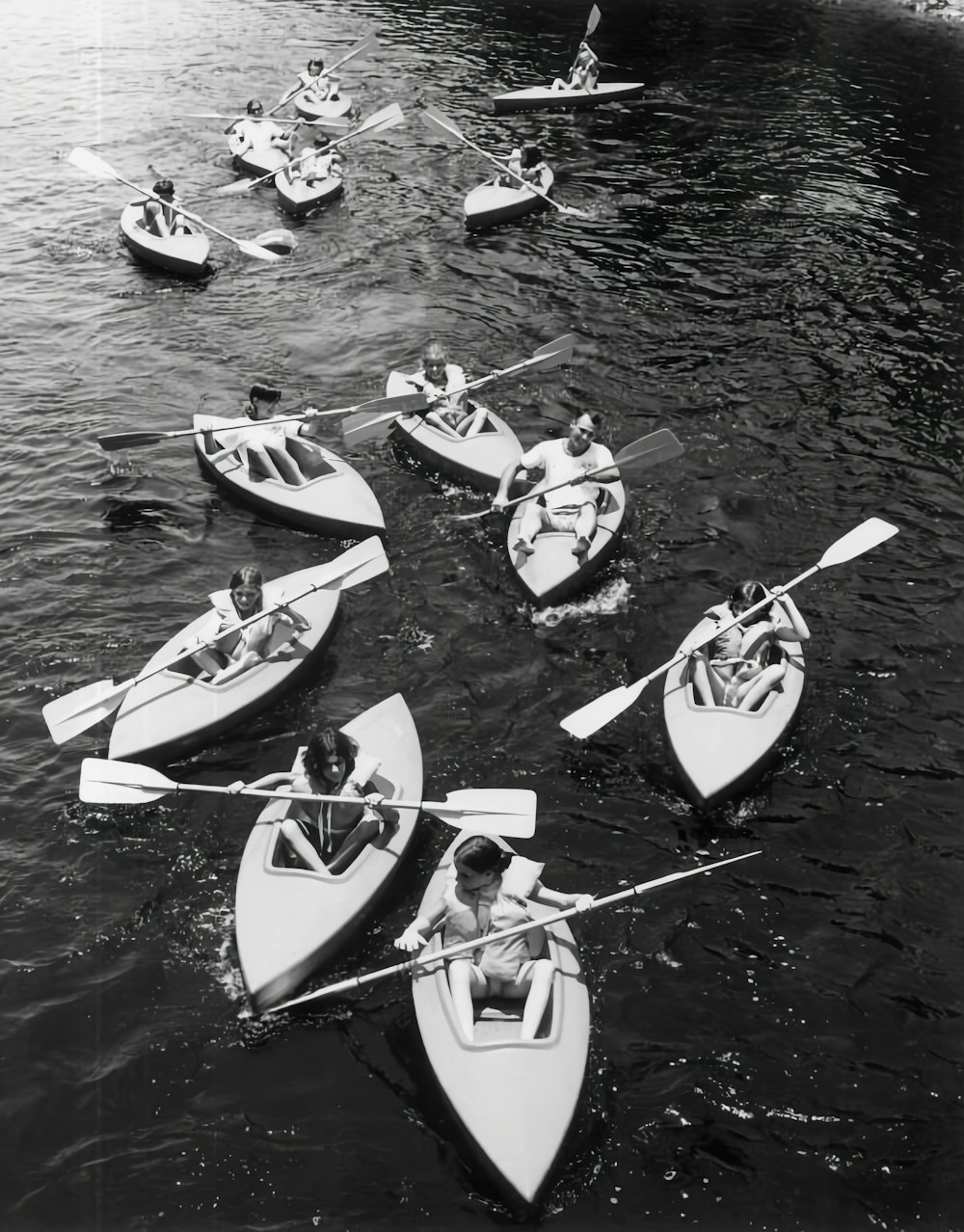 a group of people riding paddle boats on a body of water