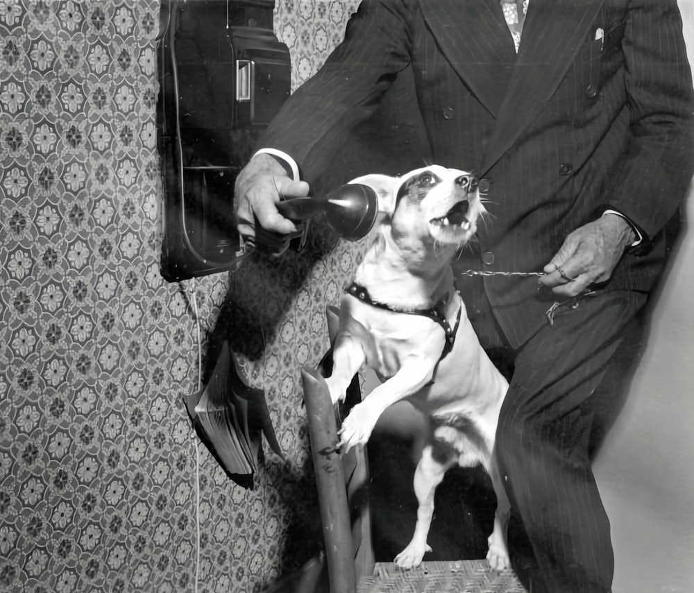 a black and white photo of a man with a dog