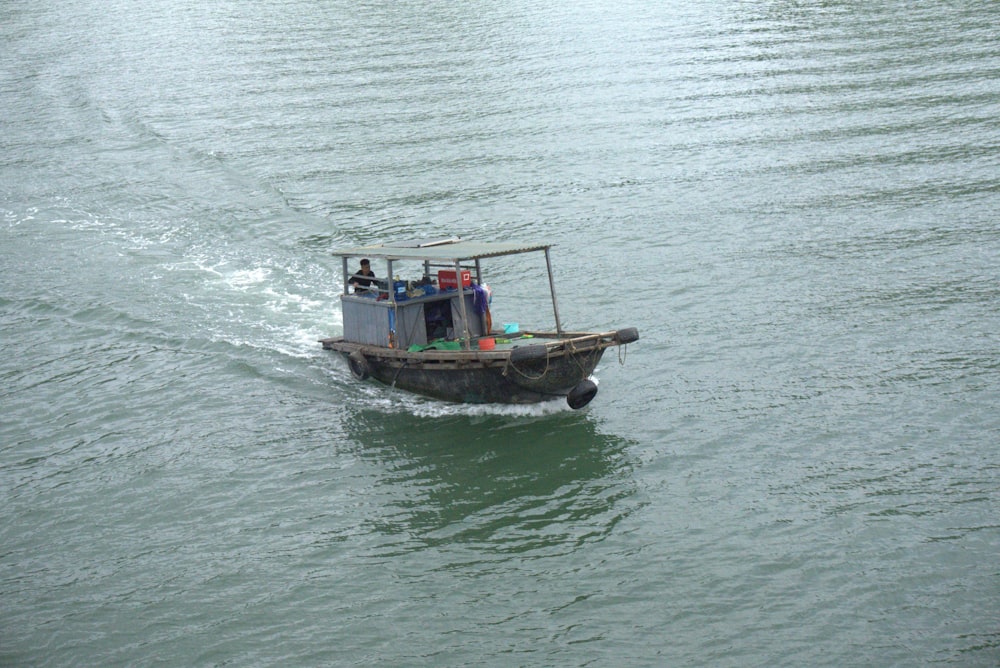 a small boat with people on it in the water