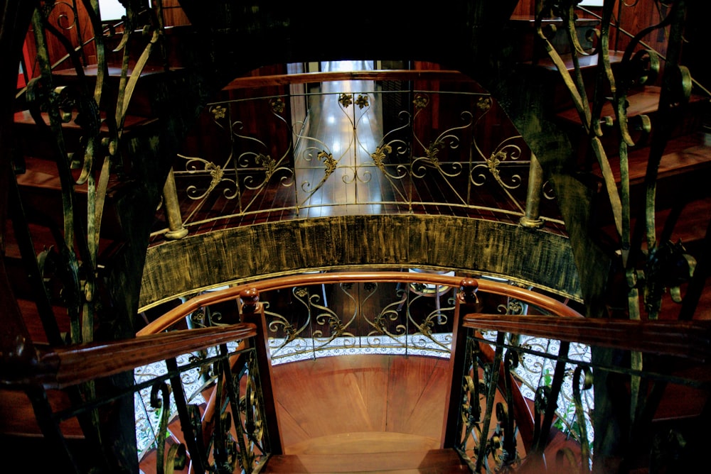 a spiral stair case in a building with a clock on it