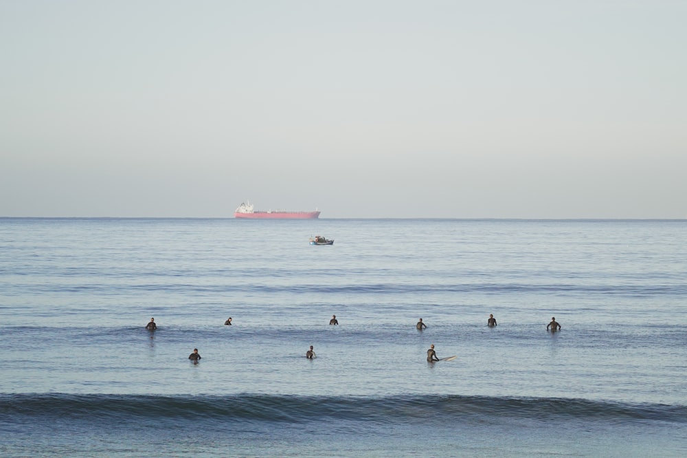 a group of people swimming in the ocean