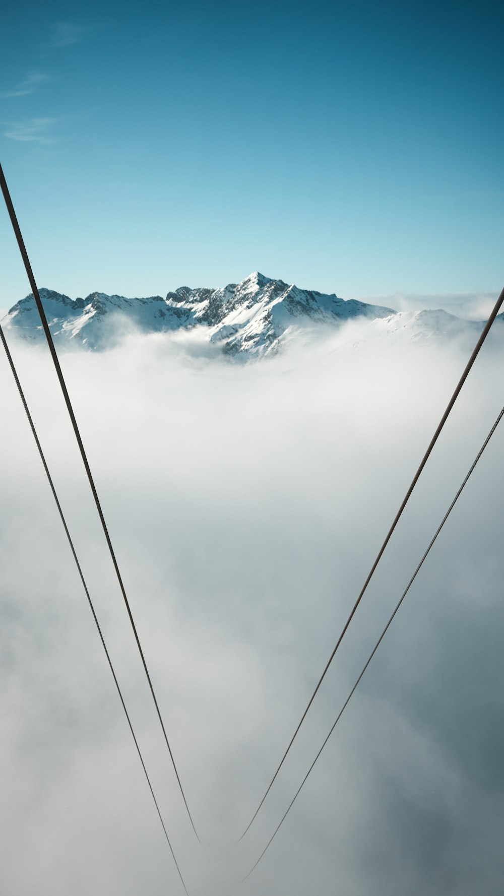 a pair of skis sitting on top of a snow covered mountain