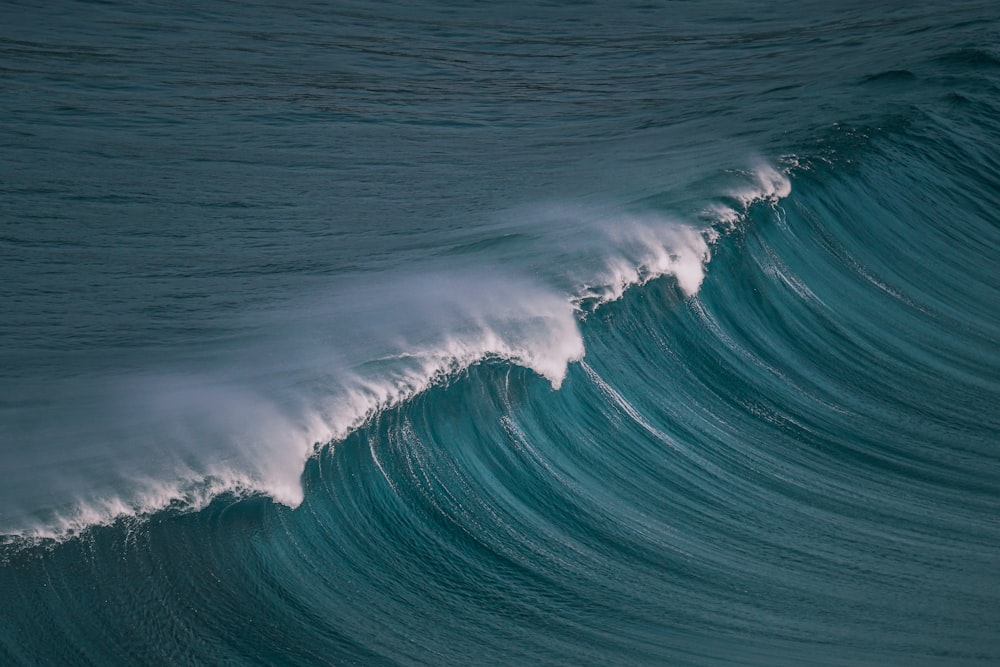 a large wave in the middle of the ocean