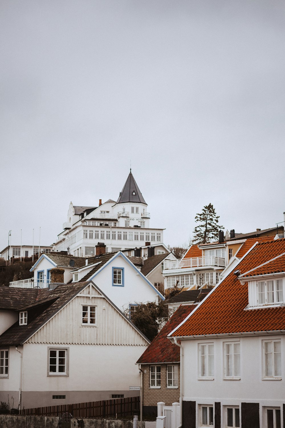 a row of houses with a large white building in the background