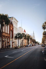 a street lined with tall buildings and palm trees