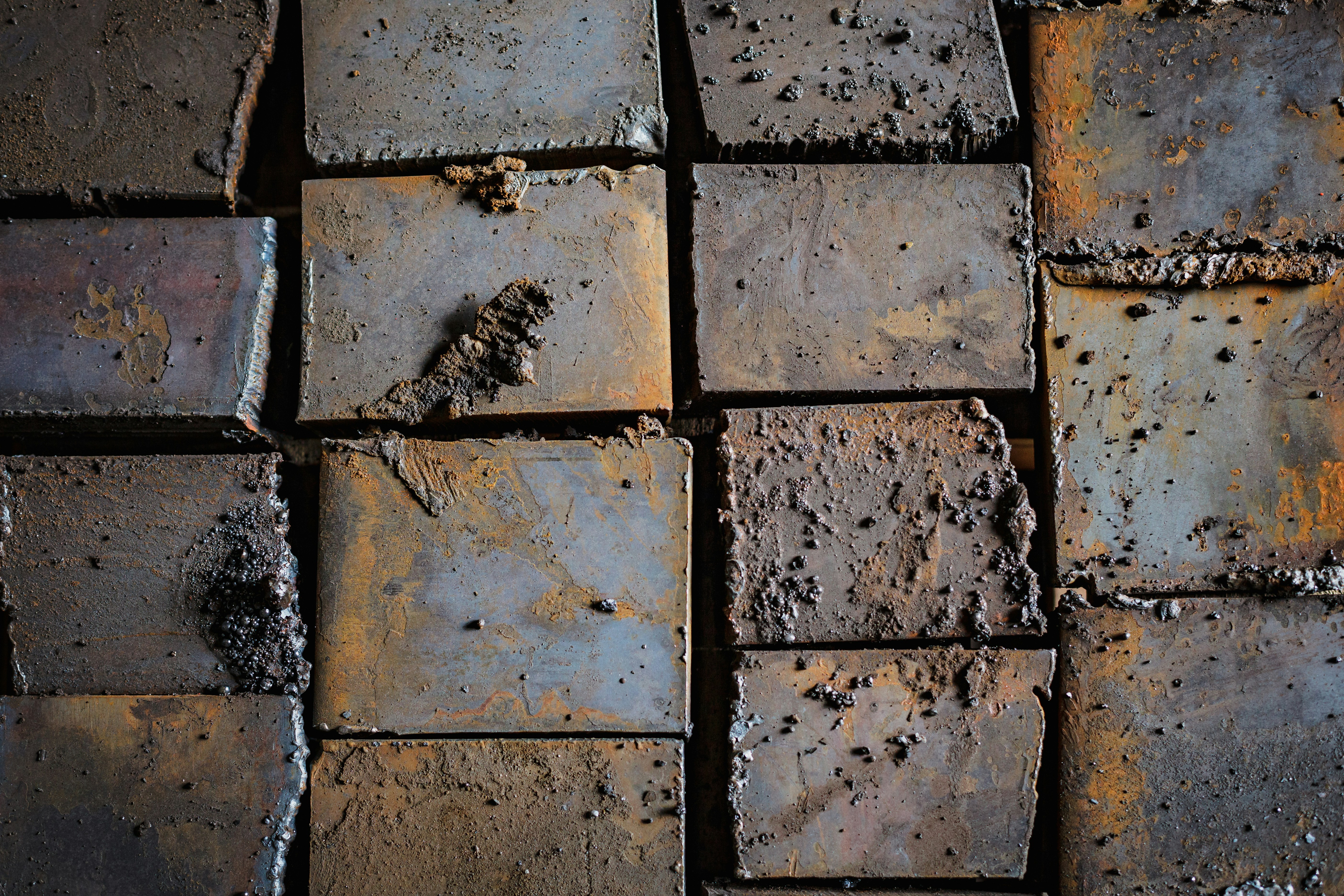 a close up of a brick wall with dirt on it