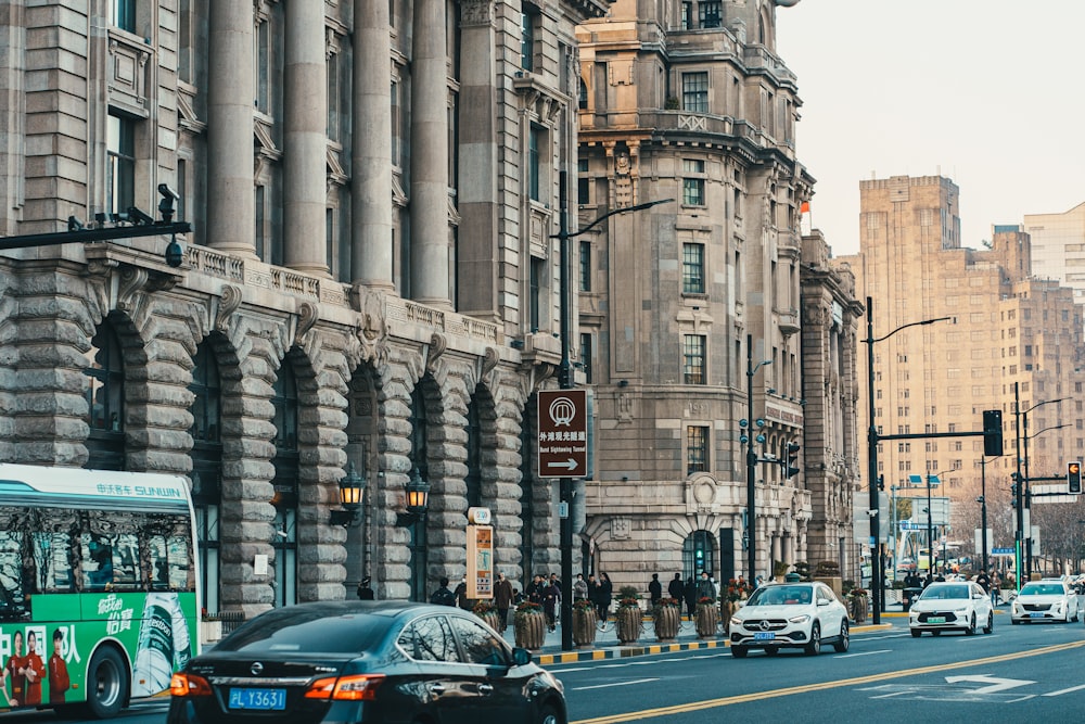 a city street filled with traffic next to tall buildings