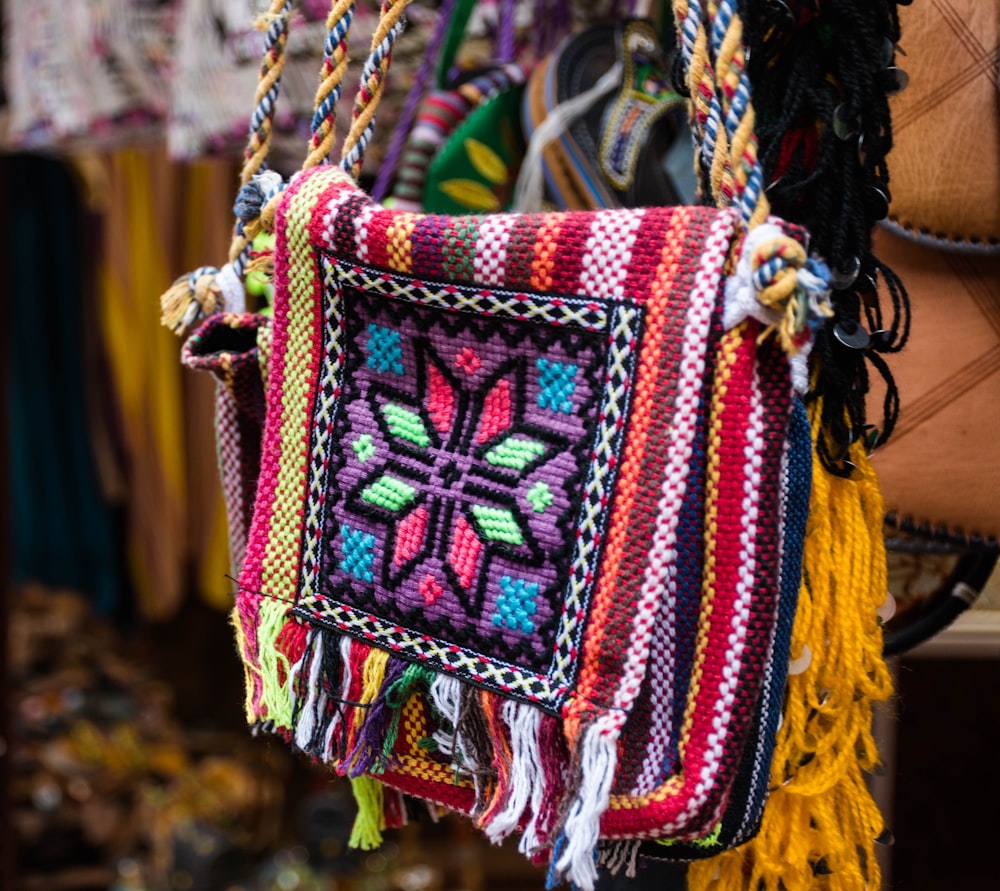 a multicolored bag hanging from a rope