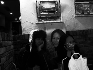 A vintage photo-style image of two friends wearing funky glasses and goofy hats.