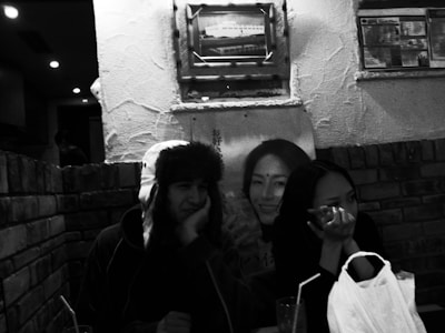 A vintage photo-style image of two friends wearing funky glasses and goofy hats.