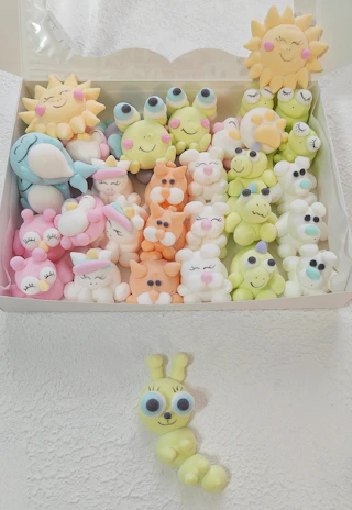 A joyful moment of a customer unwrapping a gift box filled with assorted mallowcraft marshmallows.