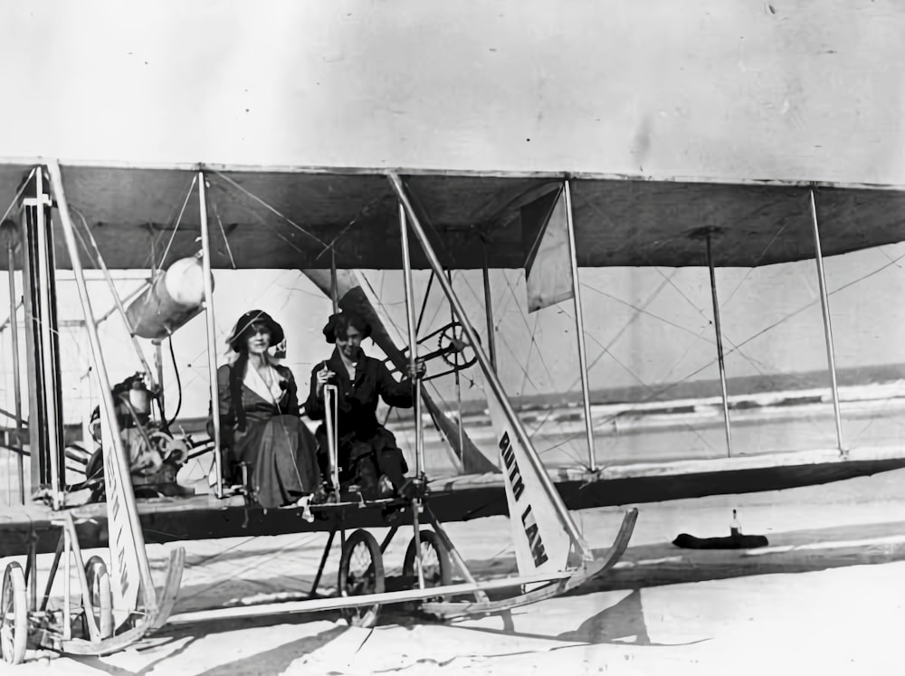 a couple of women standing next to an airplane