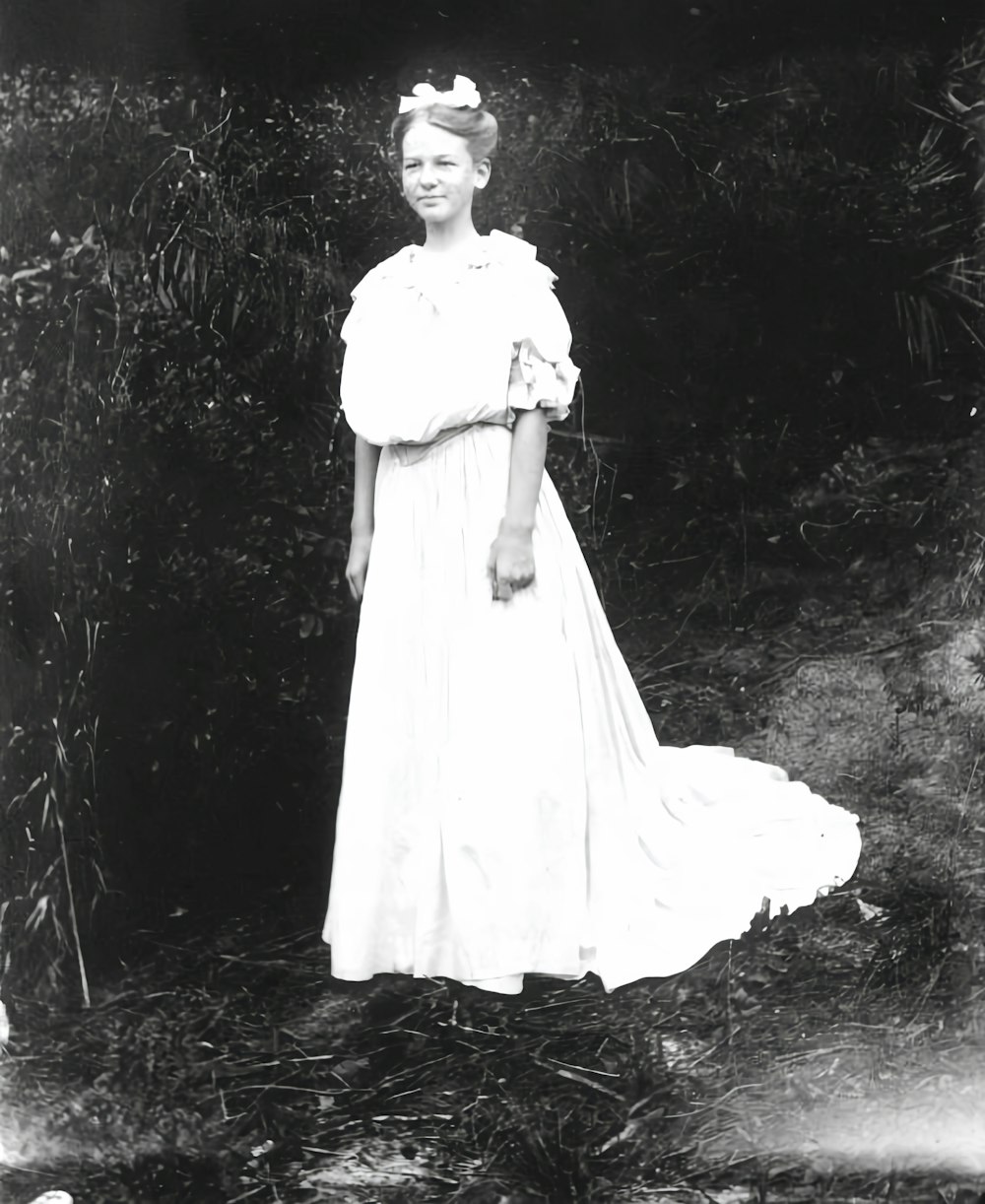 an old photo of a woman in a dress