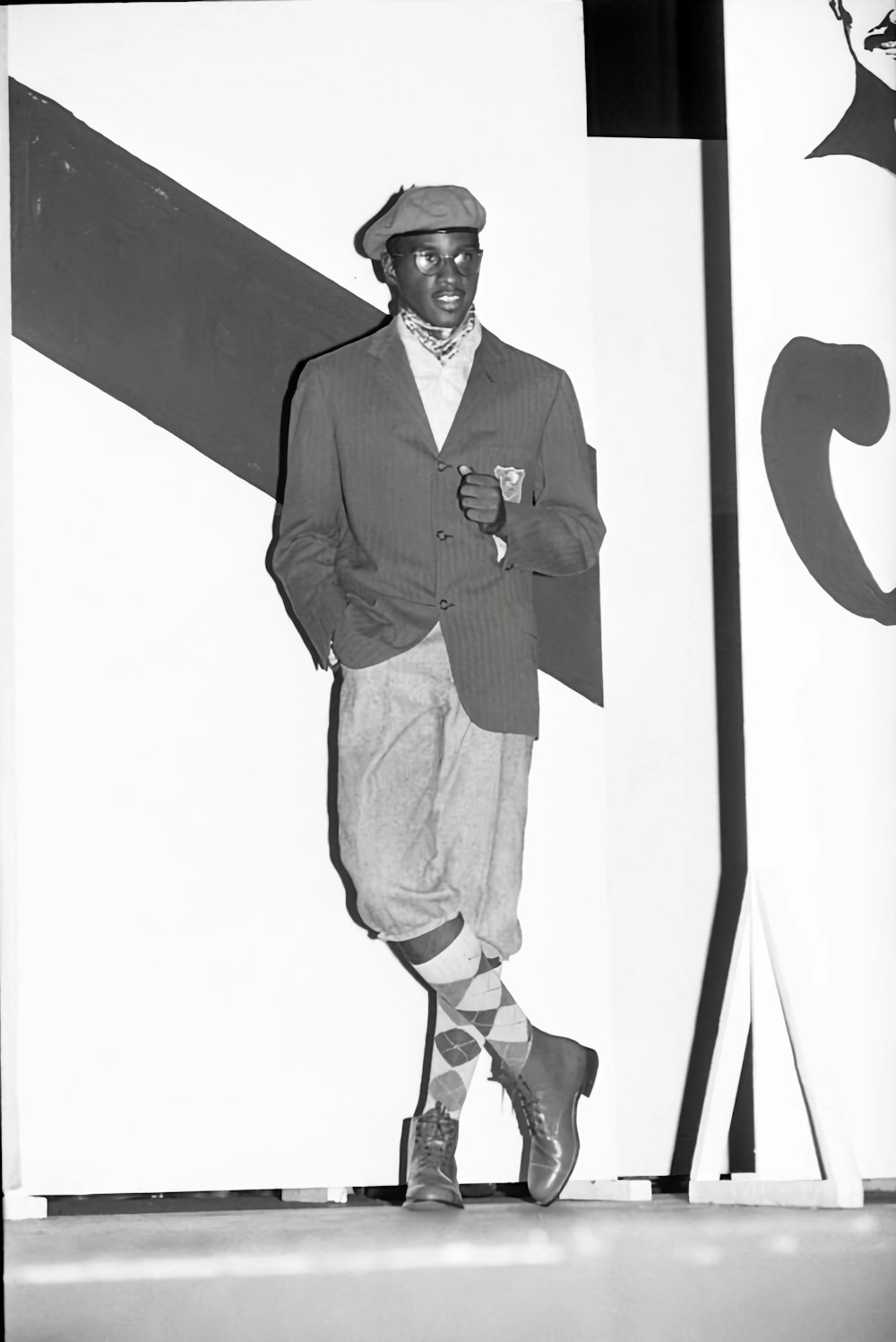 a black and white photo of a man in a suit