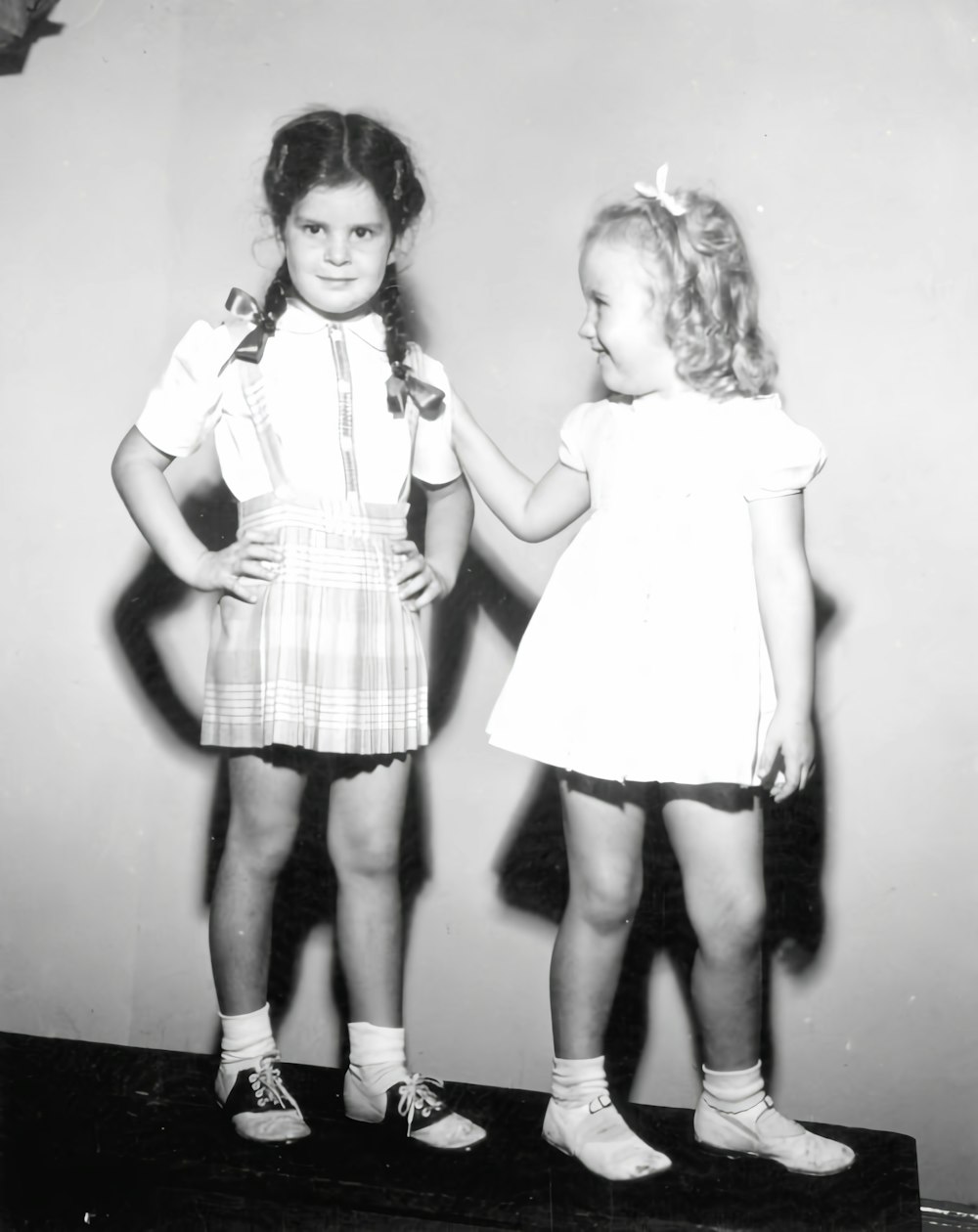 two little girls standing next to each other