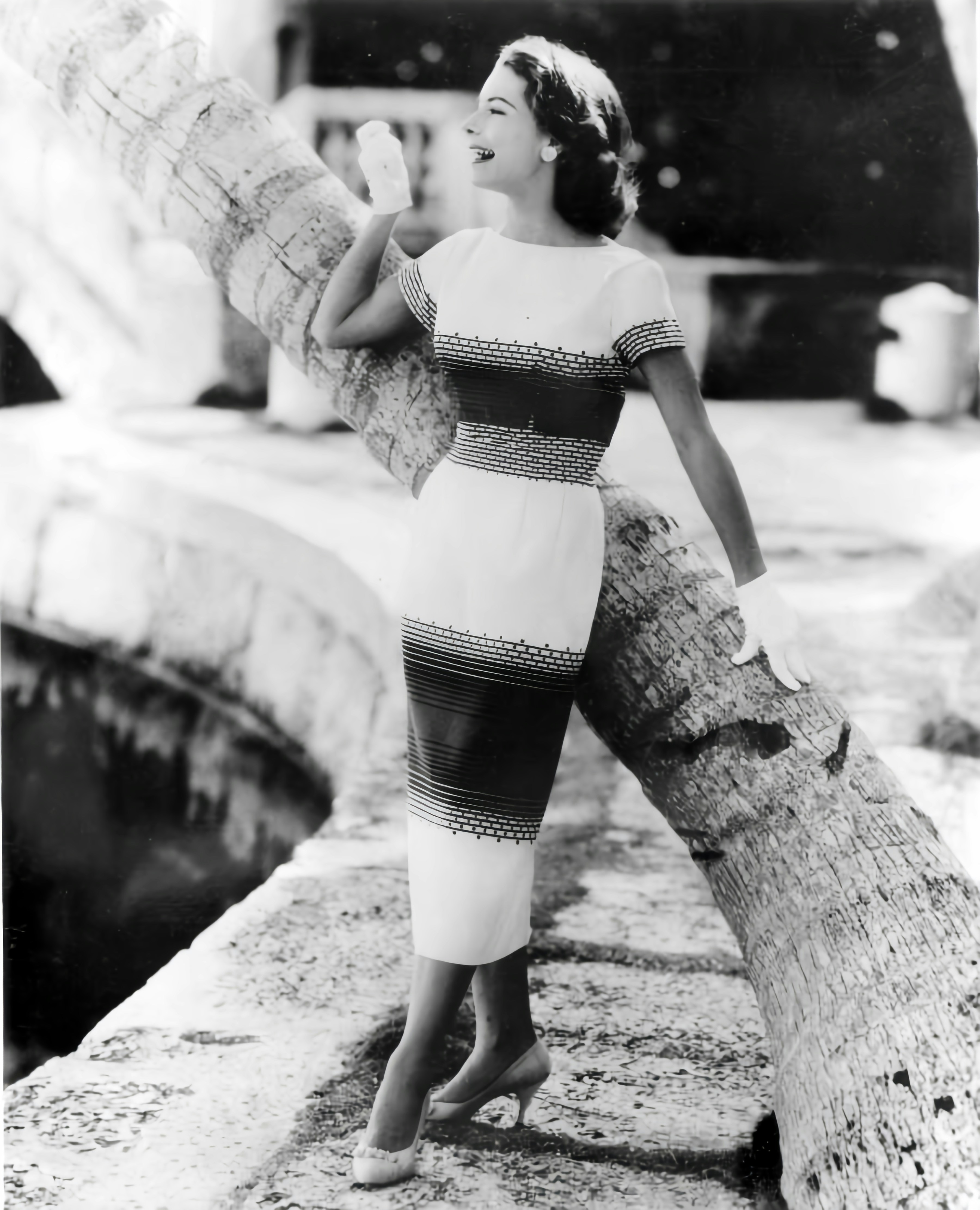 A woman in a dress leaning on a tree trunk photo – Free Dress Image on ...