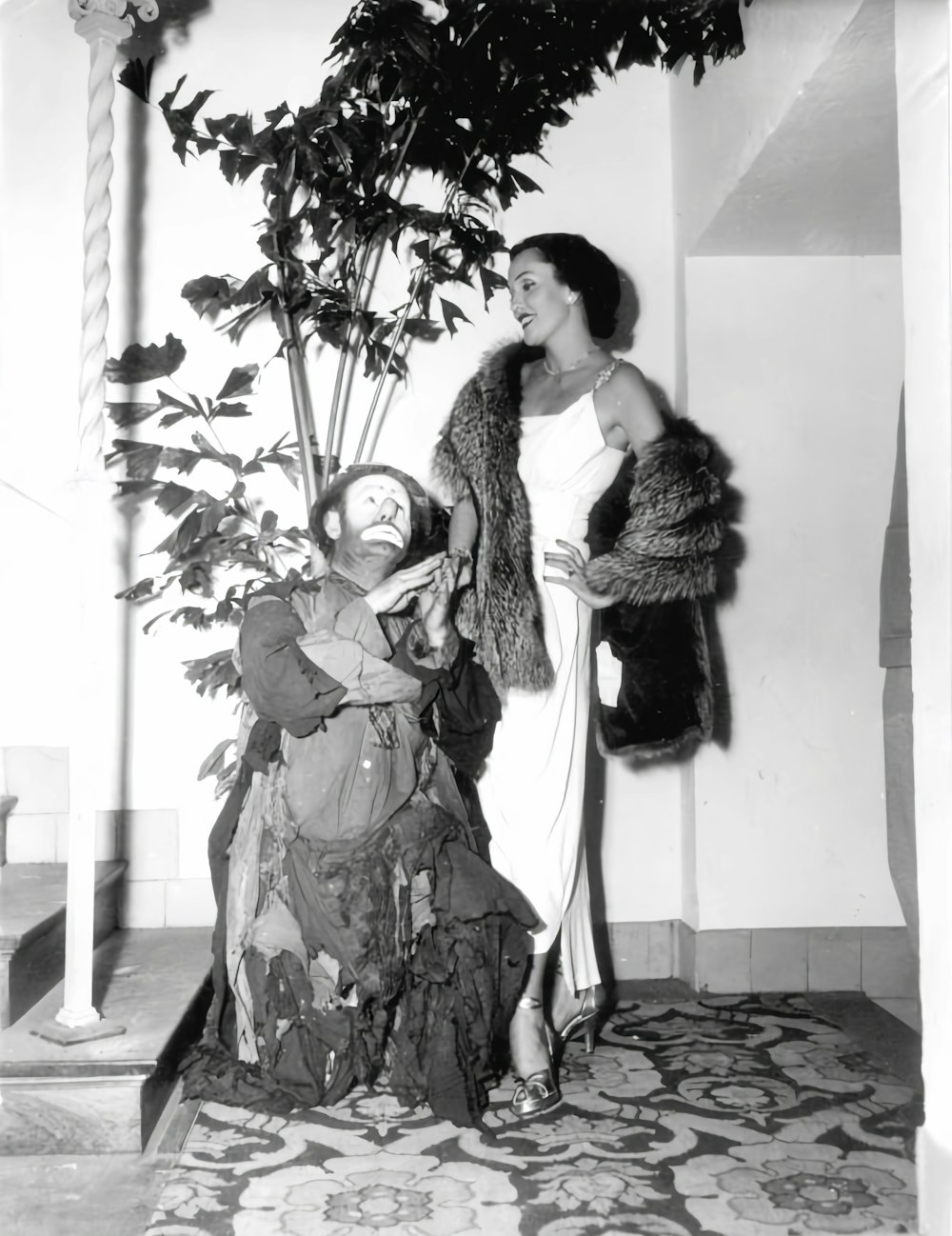 a woman standing next to a statue of a woman