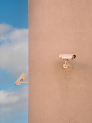a security camera mounted to the side of a building