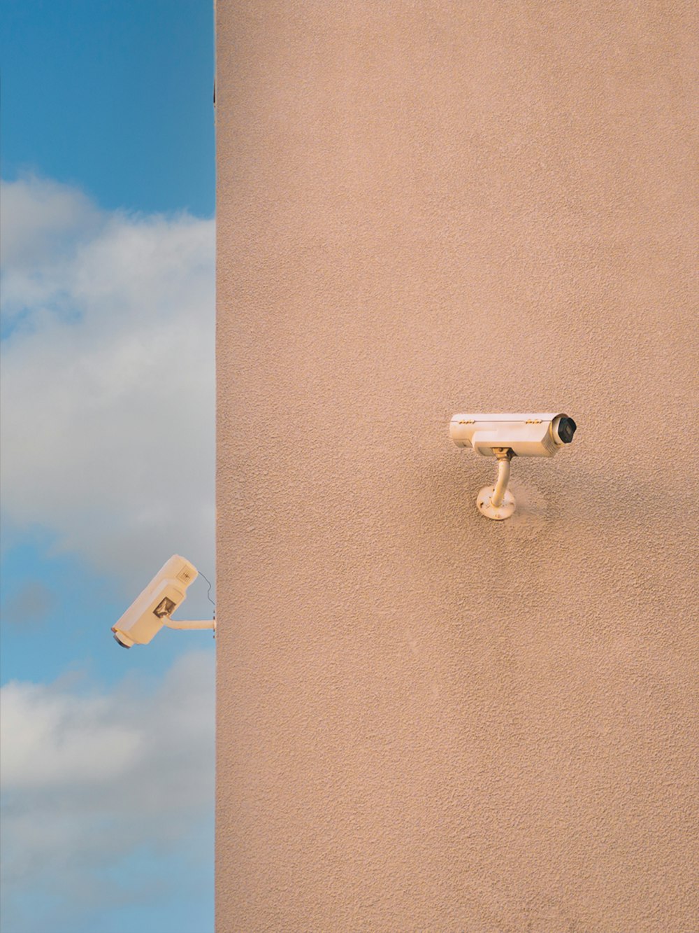 a security camera mounted to the side of a building