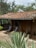Happy family enjoying their eco-friendly house surrounded by greenery in Jalisco.