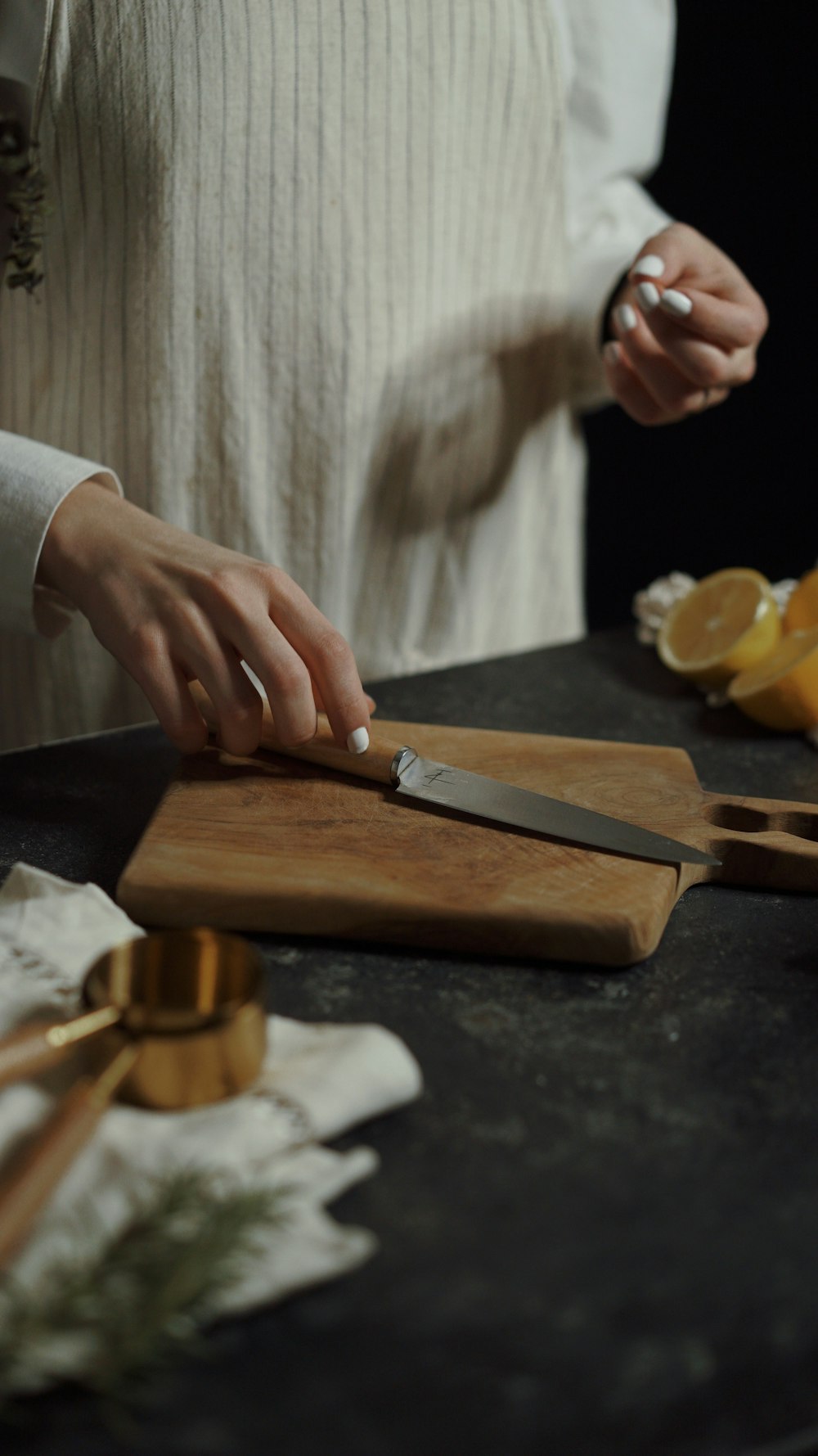 a woman is cutting oranges on a cutting board