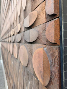 Close-up of a handcrafted wooden geometric wall art with natural wood textures.